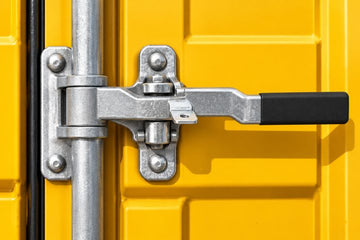 Shipping container door handle with a rubber sleeve